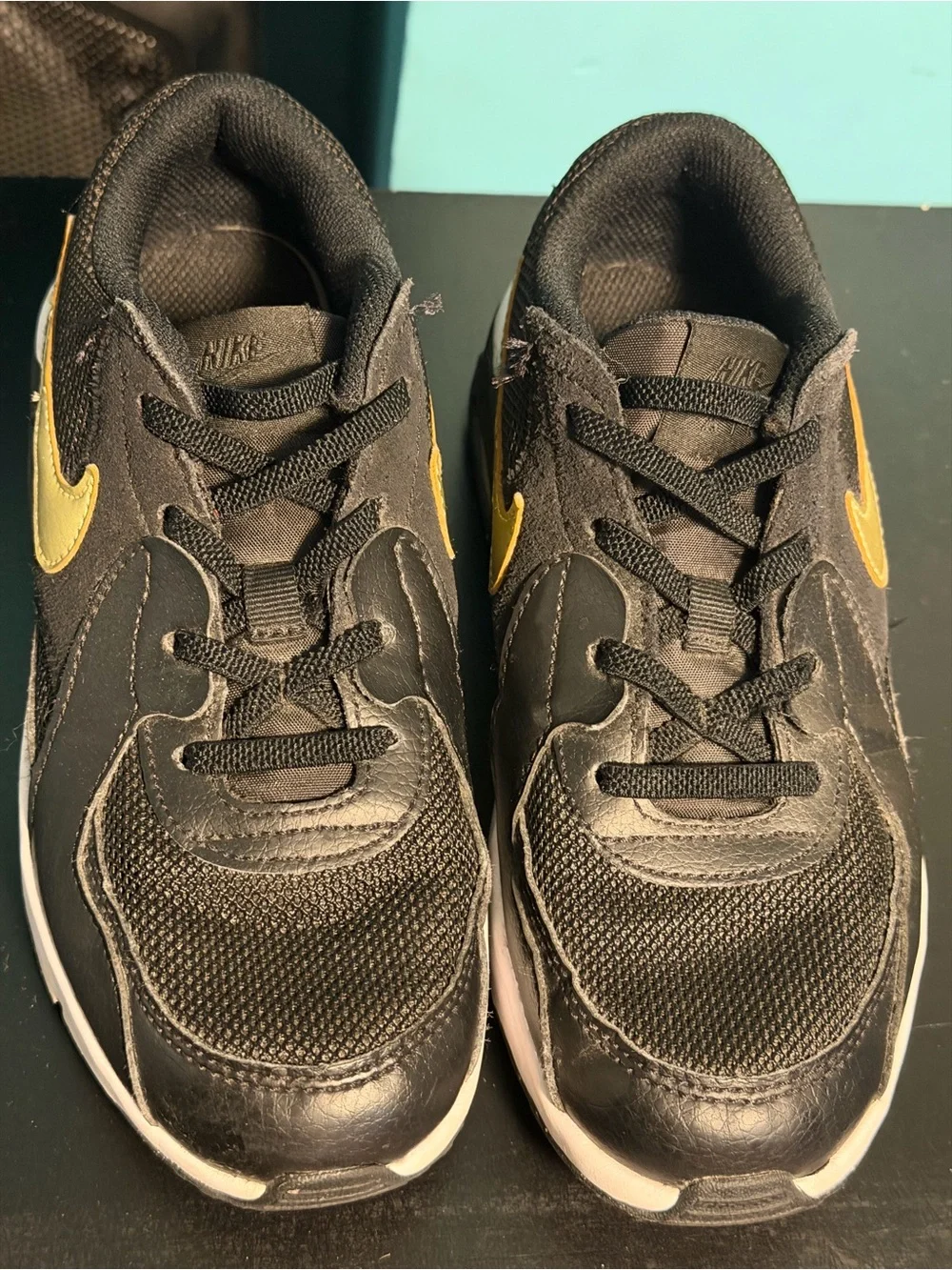 Nike Kids Black Sneakers with Gold Swoosh